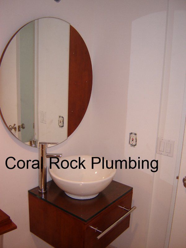 A bathroom with coral rock plumbing written on the bottom